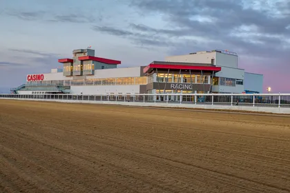 Century Mile grandstand across the racetrack at dusk